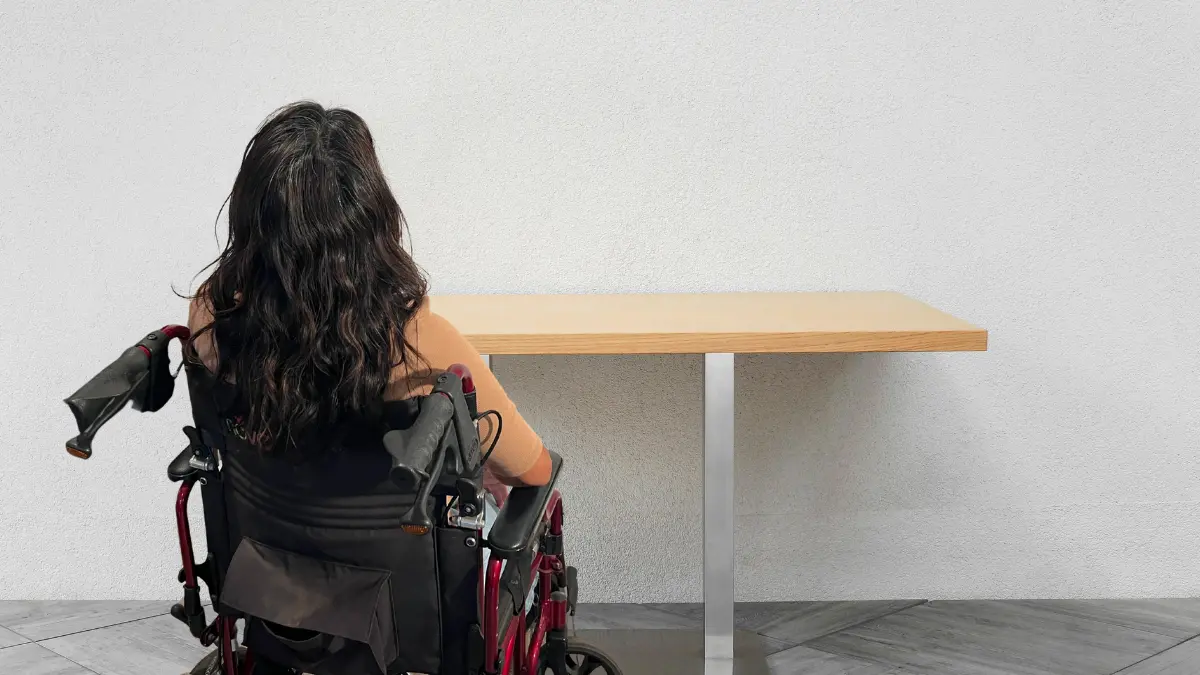 Attorneys meeting with a client at a table reviewing documents